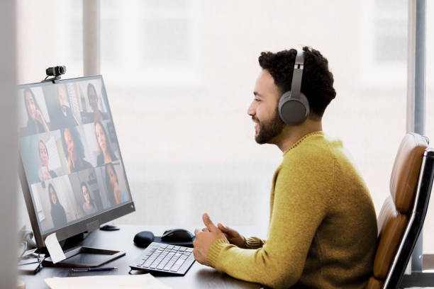 istock Man in Headphones Participating in a Video Conference 2200897737