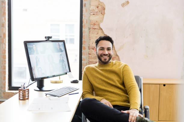 istock Smiling businessman on video call in office, using laptop 2200897746