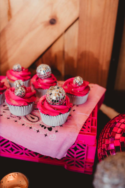 istock Pink cupcakes with disco ball topping and copy space 2200902443