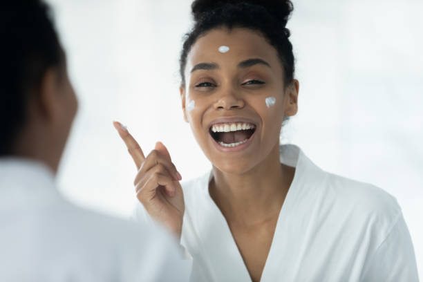 istock African American woman use moisturizing face cream in bath 2200904953