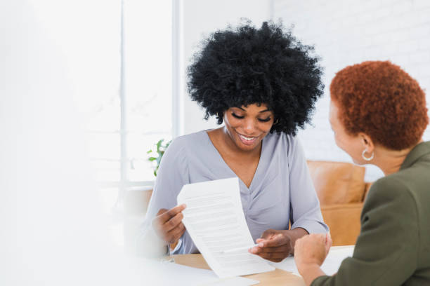 istock Two Women Reviewing Documents Together in Office 2200908375