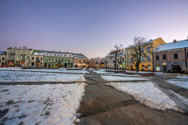 Main square of Kielce at sunset in winter with light snow