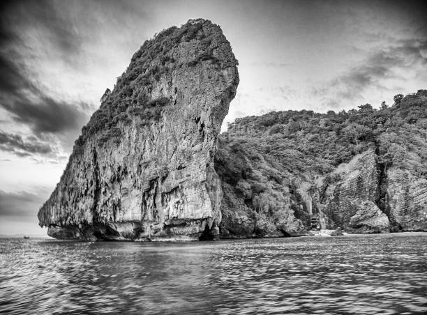 Long-tail boats silhouetted against a stunning sunset at Nui Beach, Phi Phi Don.