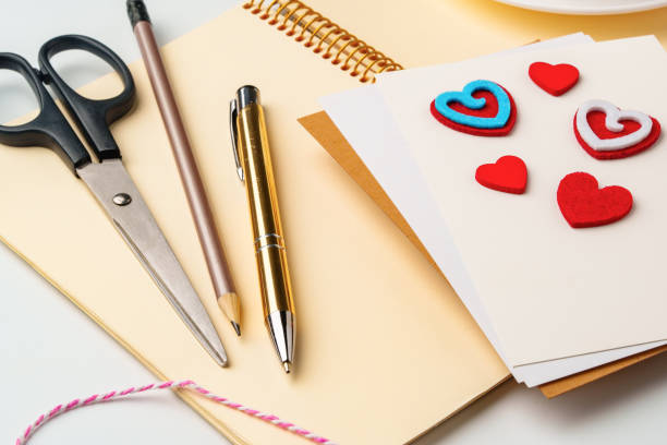 istock Creative workspace for making handmade greeting cards with colorful hearts and stationery 2200910171