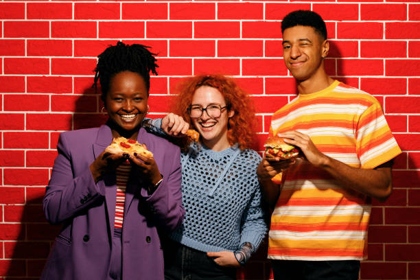 istock Friends Enjoying Fast Food Together 2200910926