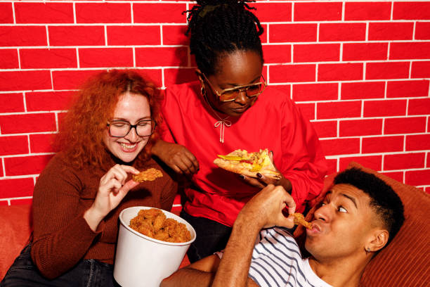 istock Friends Enjoying Fast Food Together 2200910952