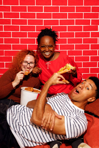 istock Friends Enjoying Fast Food Together 2200910953