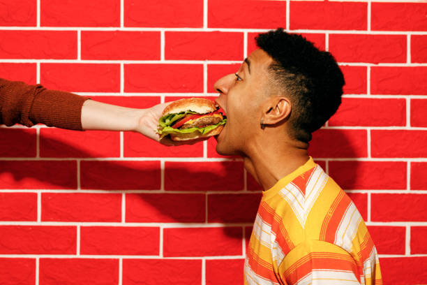 istock Playful Fast Food Moment with Burger 2200910985