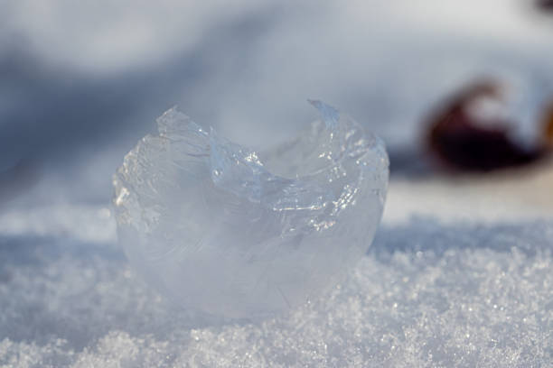 A macro photo with a close up view of a frozen soap bubble that was too delicate so it popped and now looks like broken glass.