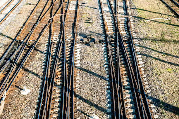 A railway junction with crossing parallel railroad tracks. Perspective view of railway tracks interchanges. Concept of choosing a path or route. Industrial background. Top view