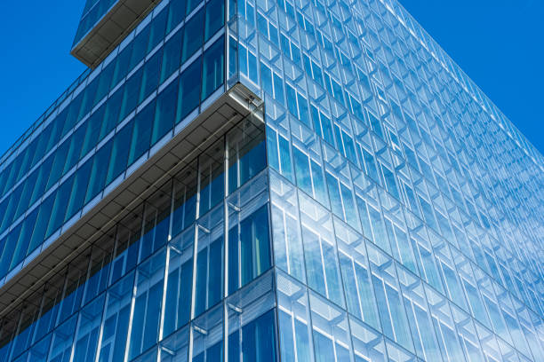 Looking up the glass facade of a large office complex