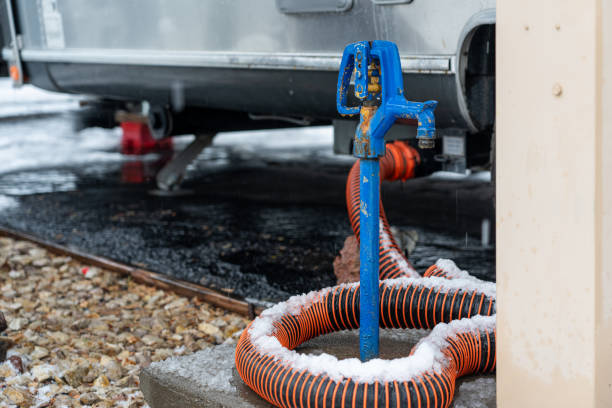 RV trailer sewer hose covered in snow