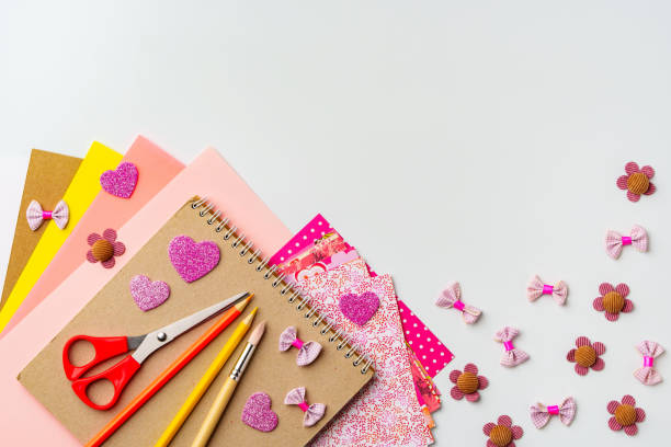istock Crafting materials arranged for creative projects with colorful papers and decorative items 2200917844