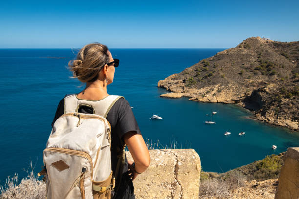 istock Girl with backpack looking at the sea 2200918661