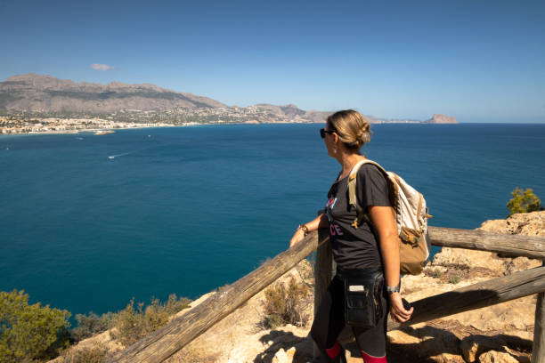 istock Girl with backpack looking at the sea 2200918669