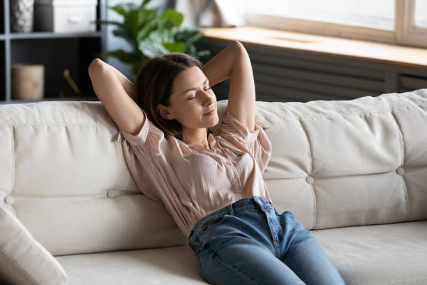 istock Relaxed housewife completed chores reduces tiredness leaned on couch 2200922056
