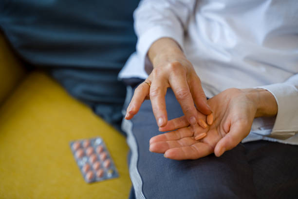 istock Senior woman taking pills from blister pack 2200923415
