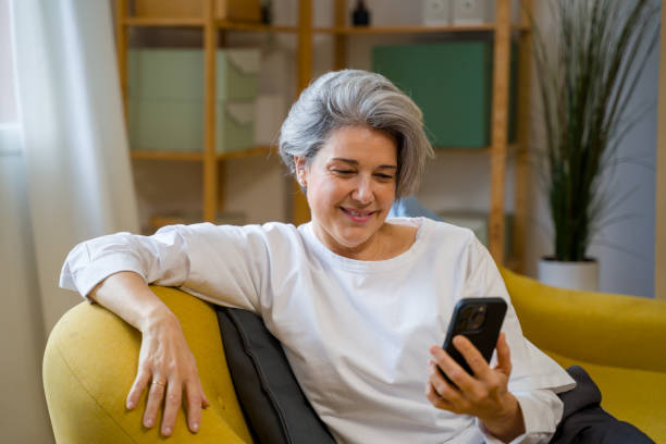 istock mature woman using smartphone 2200924004