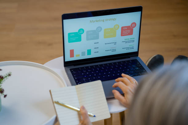 istock Marketing manager analyzing marketing strategy on a laptop and taking notes 2200926827