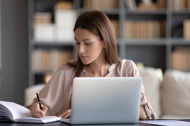 istock Housewife writing on personal organizer useful information founded in internet 2200927188