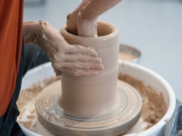 istock Close-up of a potter's hands making a ceramic vase on a potter's wheel. 2200928641