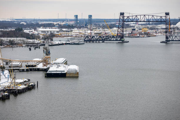 Ships, boats are docked at bustling port, reflecting activity on scene features variety of vessels scenic view of landscape