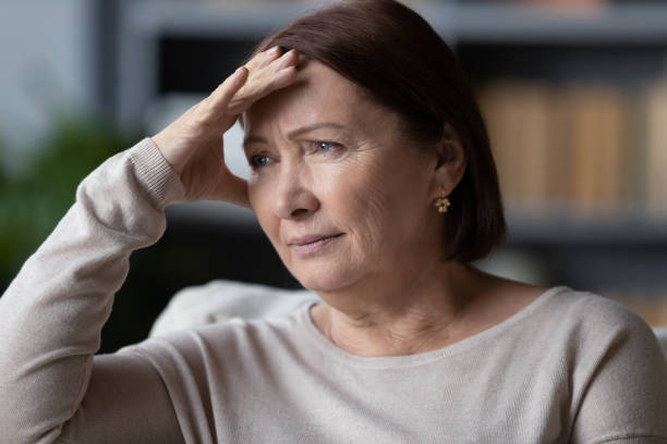 Attractive 60s woman thinking about life troubles feels concerned