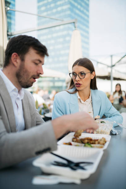istock Business colleagues having lunch together at a rooftop restaurant 2200932921