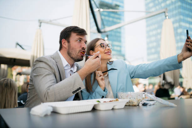 istock Business colleagues enjoying lunch break and taking selfie 2200933520