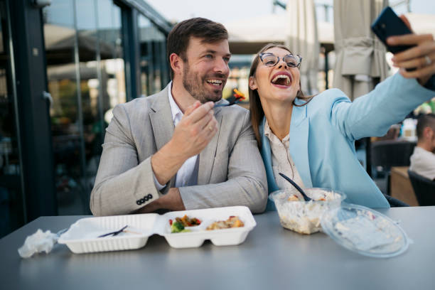 istock Business colleagues enjoying lunch break and taking selfie 2200933524