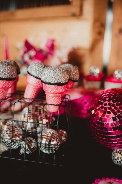 istock Pink and silver cupcakes in ice cream cones with disco ball decorations 2200935884