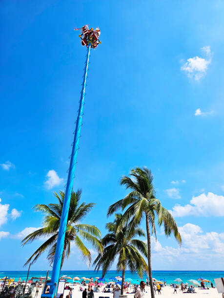 The Papantla Flyers, also known as Voladores de Papantla, are a group of men who perform a traditional Mexican ritual that involves climbing a pole and jumping into the air. The ceremony is a fertility ritual that is meant to bring rain and prosperity. Location: Playa del Carmen, Mexico