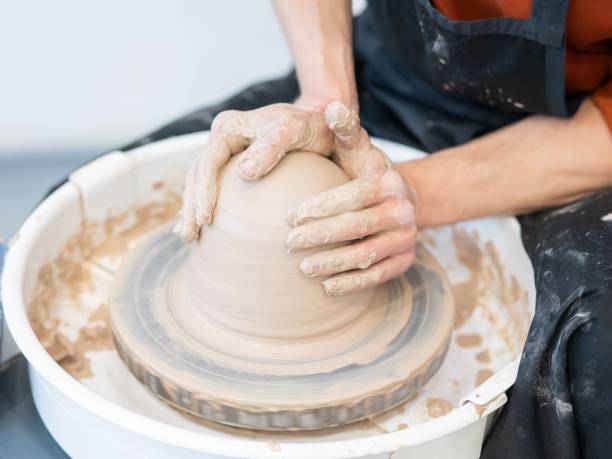 istock Close-up of a potter's hands working on a pottery wheel. 2200948097