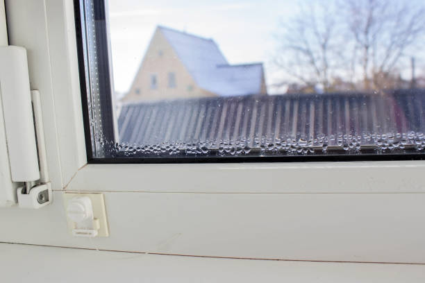 istock Close-up of condensation on a PVC window, white plastic window, humidity concept. 2200953402
