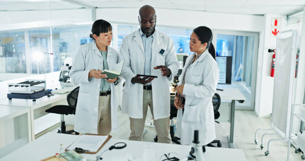 istock Science, people and tablet in lab for advice, brainstorming and innovation for medicine development. Scientists, research team and tech in facility for learning, mentorship and planning in discussion 2200954097