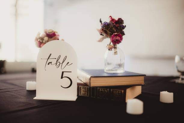 istock Wedding table setting with table number and flower centerpiece 2200954327