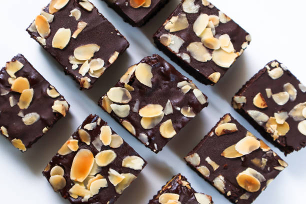 istock Set Chocolate Brownies pieces with topping almond slice on white background. Top view 2200954921