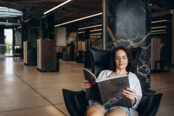 istock Happy brunette female interior designer choosing flooring tile color texture samples at store shop. Woman architect choice floor and wall finishing material for architecture and construction industry 2200957721