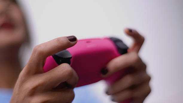 Young asian woman hand holding a joy controller enjoy play game.