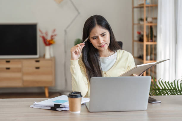 istock Serious businesswoman working from home, focused on freelance projects and managing tasks. 2200960136