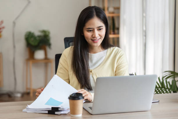 istock Freelance professional reviewing documents and managing tasks from home office, highlighting organization and efficiency. 2200960221