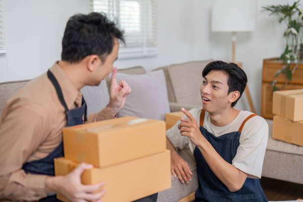 istock Engaged online sellers brainstorming packaging solutions in a relaxed home setting. 2200962227