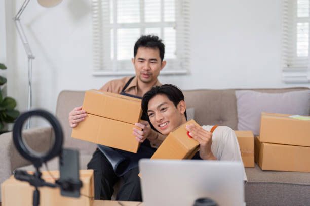 istock Diverse online sellers preparing packages for shipment at home, collaborating on e-commerce business. 2200962453