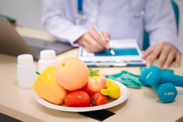 istock A male nutritionist sitting at a table, advising on healthy diets, promoting vegetable-based meals, supplements, weight loss, and meal planning to improve overall health and well-being 2200963349