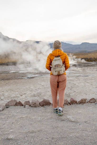 istock Traveler in Yellow Jacket Exploring Geothermal Landscape 2200965139