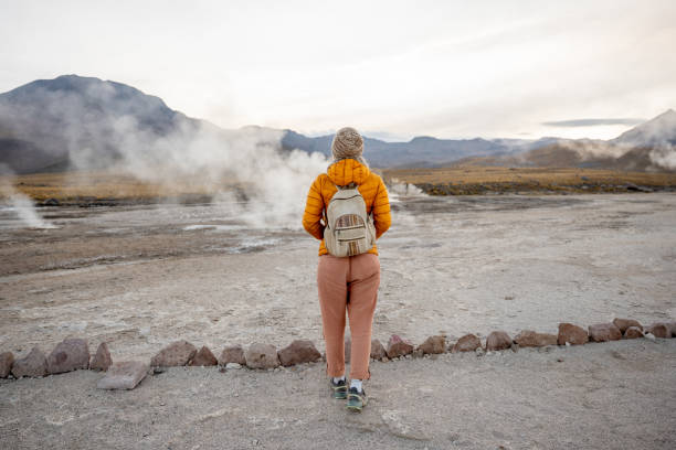istock Traveler in Yellow Jacket Exploring Geothermal Landscape 2200965144