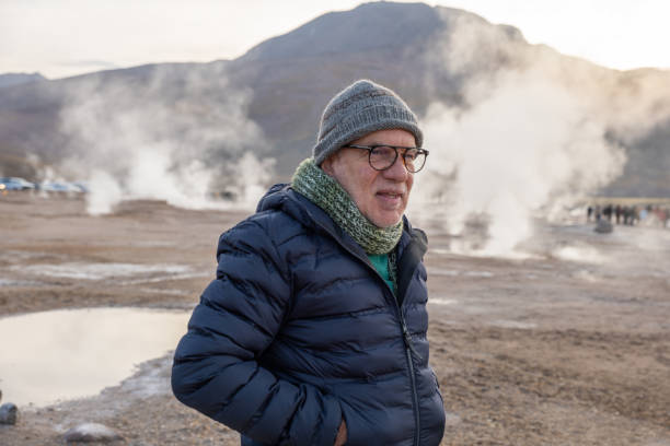 istock Senior man in winter attire enjoying a geothermal area 2200965258