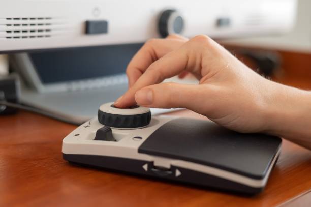 istock A woman uses a special magnification device for the visually impaired. 2200965286