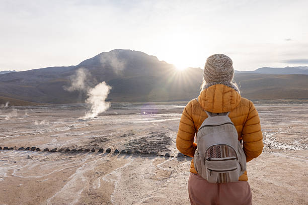 istock Woman Enjoying a Sunrise Landscape in Winter Clothing 2200966607