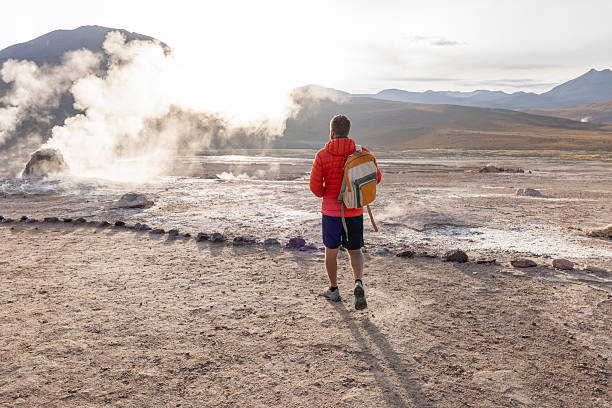 istock Man Exploring Geothermal Field at Sunrise with Backpack 2200966658